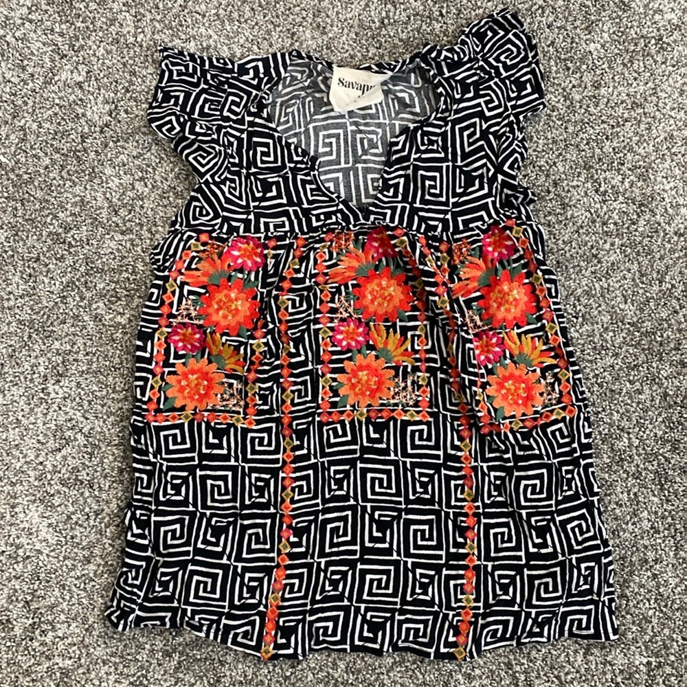 Black and white top with front with orange embroidery detailing